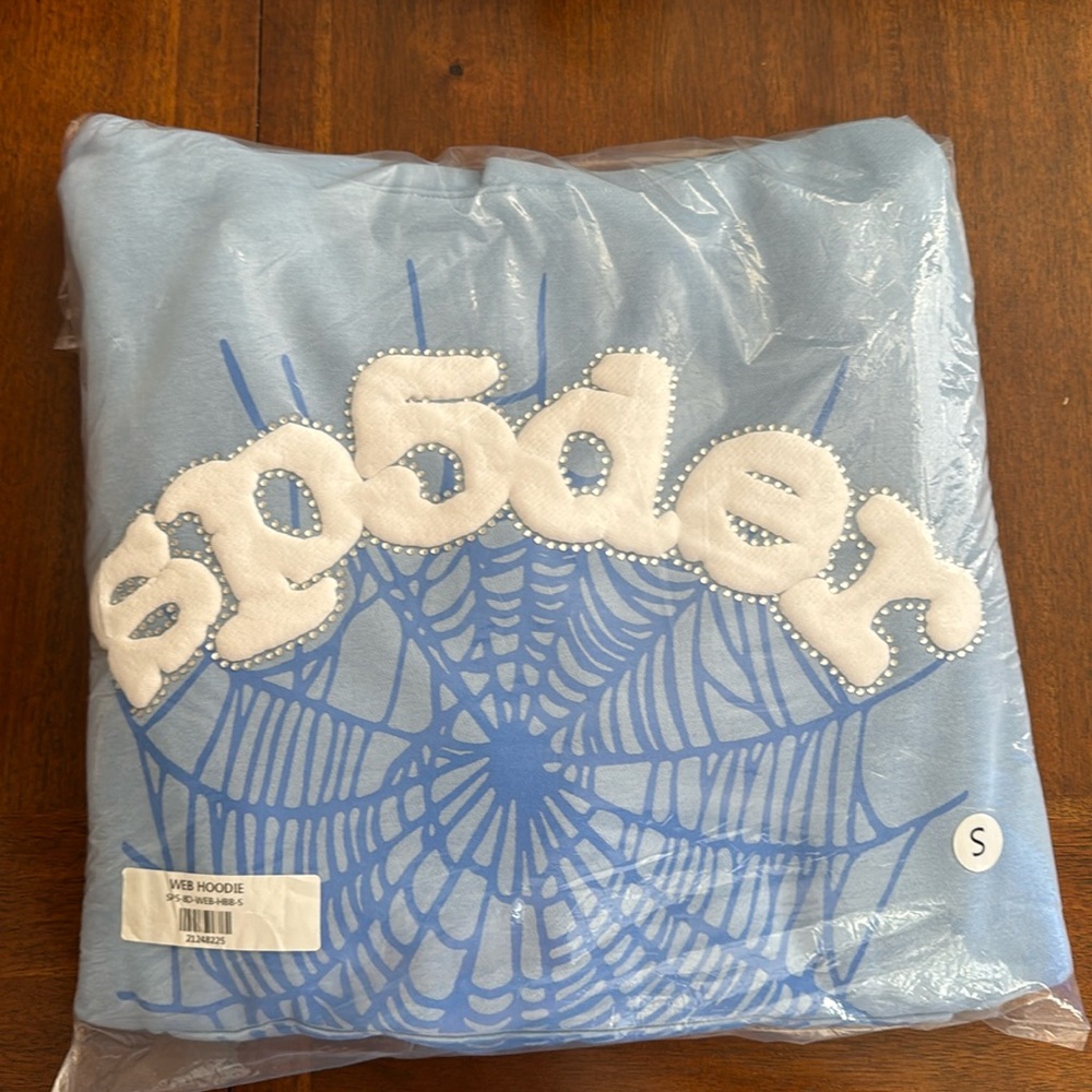 Brand: Sp5der it’s a Size Small pullover hoodie it’s a baby blue
